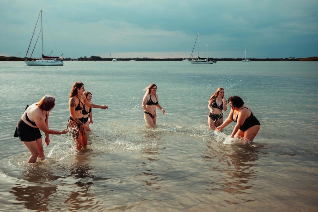 women playing in the water at the beach